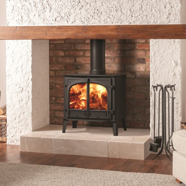 Stovax Stockton 11 Single Door Wood-Burning Stove - Lifestyle Image in a Traditional Fireplace with Raised Hearth