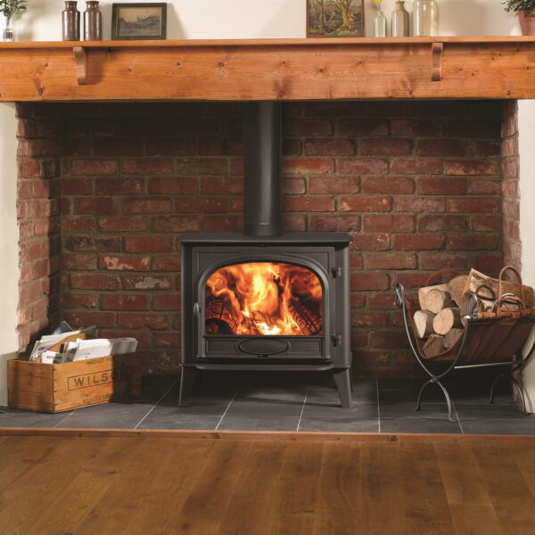 Stovax Stockton 11 Single Door Wood-Burning Stove - Lifestyle Image in a Traditional Brick Fireplace