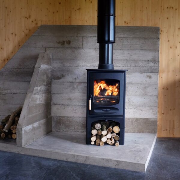 Charnwood C-Six (BLU) in Black on a Store Stand - Lifestyle Image Against a Stone Backdrop