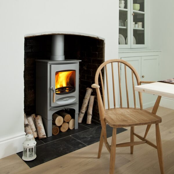 Charnwood C-Six (BLU) in Pewter on a Store Stand - Lifestyle Image in a Fireplace