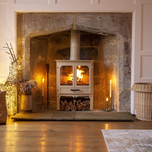 Charnwood Island II in Almond on Store Stand - Lifestyle Image in Traditional Fireplace