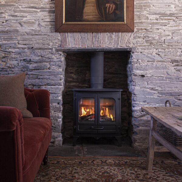 Charnwood Island II in Black on Low Legs - Lifestyle Image in Traditional Stone Fireplace