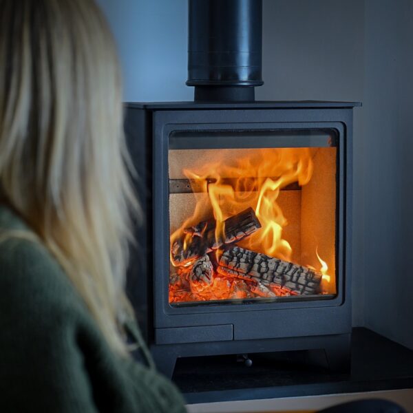 Hunter Allure 5 Wood-Burning Stove - Lifestyle Image with Blonde Woman in Foreground