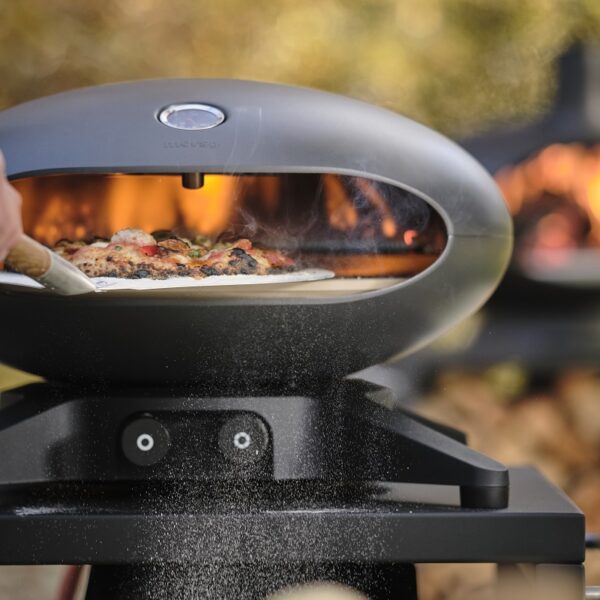 Morsø Forno Spin Outdoor Pizza Oven - Closeup Lifestyle Image - Gas Fired Electronically Rotating Pizza Cooker.