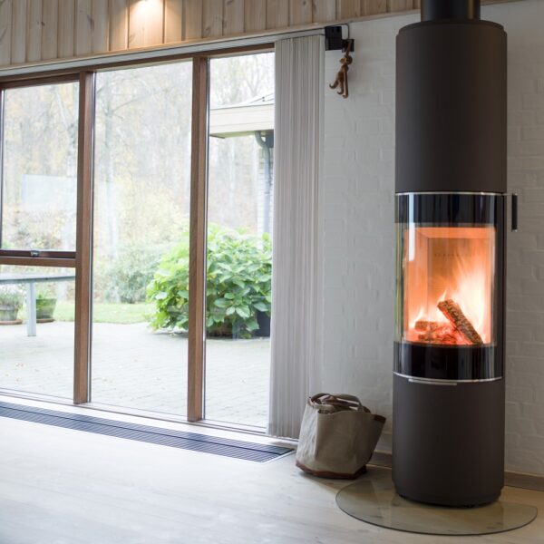 RAIS Pilar Wood-Burning Stove - Lifestyle Image in Black with Glass Door