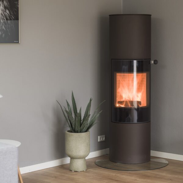 RAIS Viva L 160 Wood-Burning Stove - Lifestyle Image in Black with Glass Door and Rear Flue Outlet