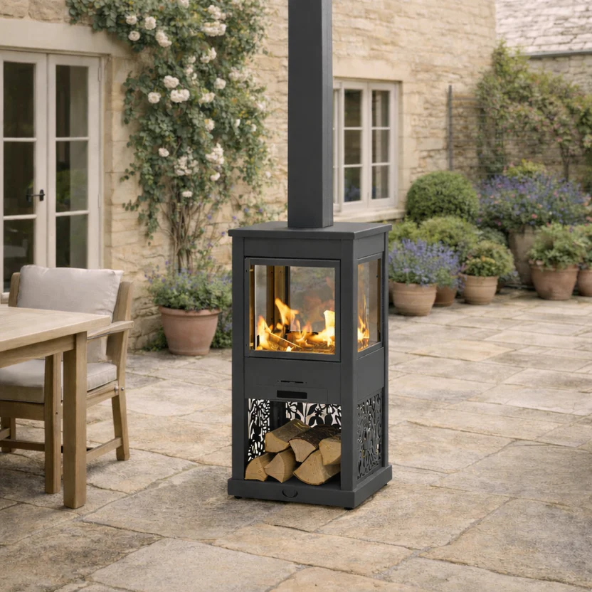 Hive_Outdoor_Wood_Burning_Stove_Four_Sided_Glass_Grey_Patio_Heater.png Hunter Pollen Hive Outdoor stove in Grey outside in garden setting