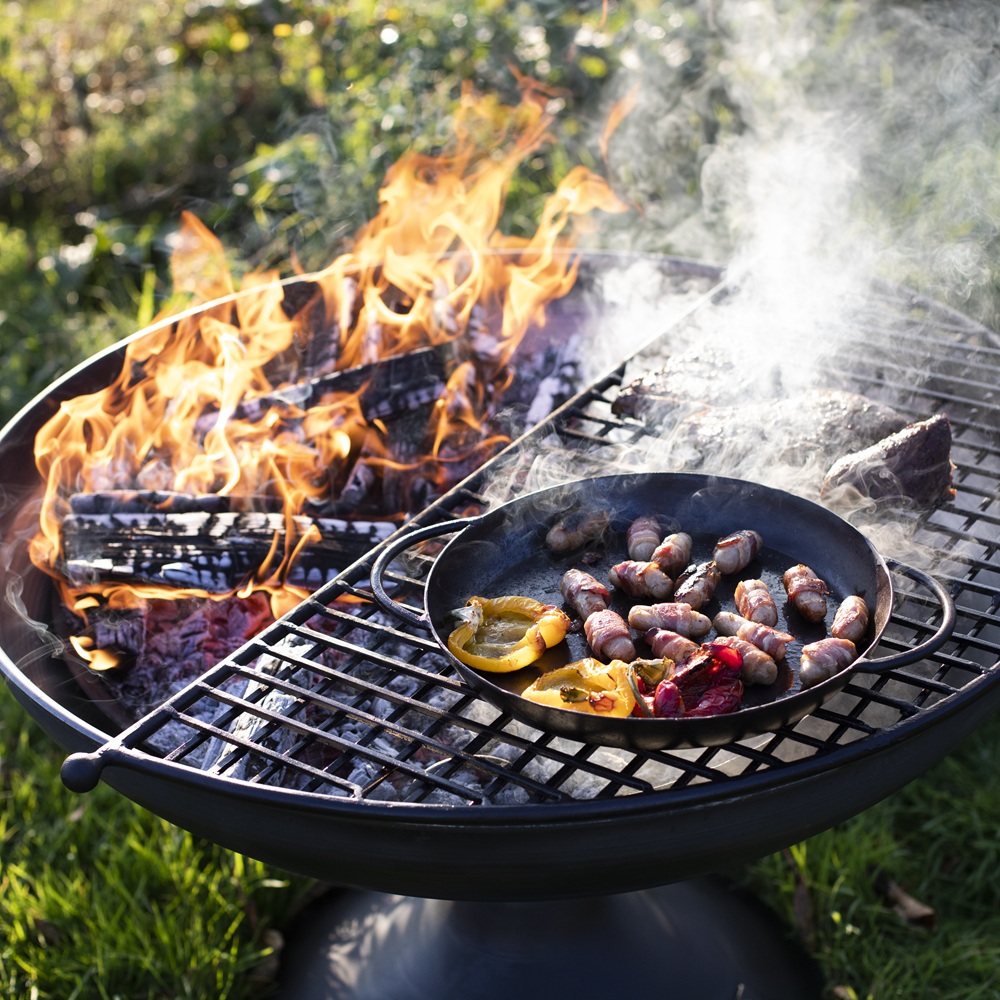 Wine Glass Fire Pit 70cm with Half Moon BBQ Grill Rack Plate & Bar - Lifestyle Image Cooking Detail