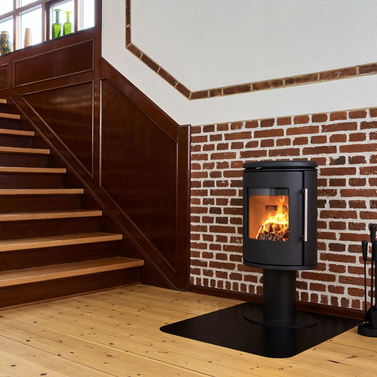Morso 6848 stove next to some brown stairs with wood burning